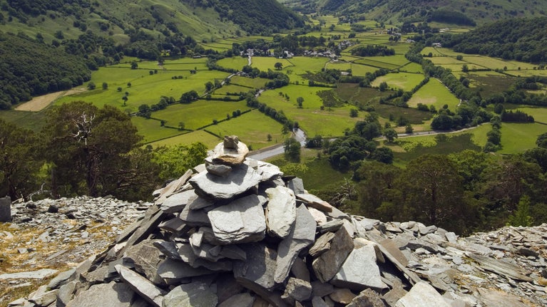 Cairn on Castle Crag overlooking the River Derwent and Rosthwaite village, Lake District, Cumbria